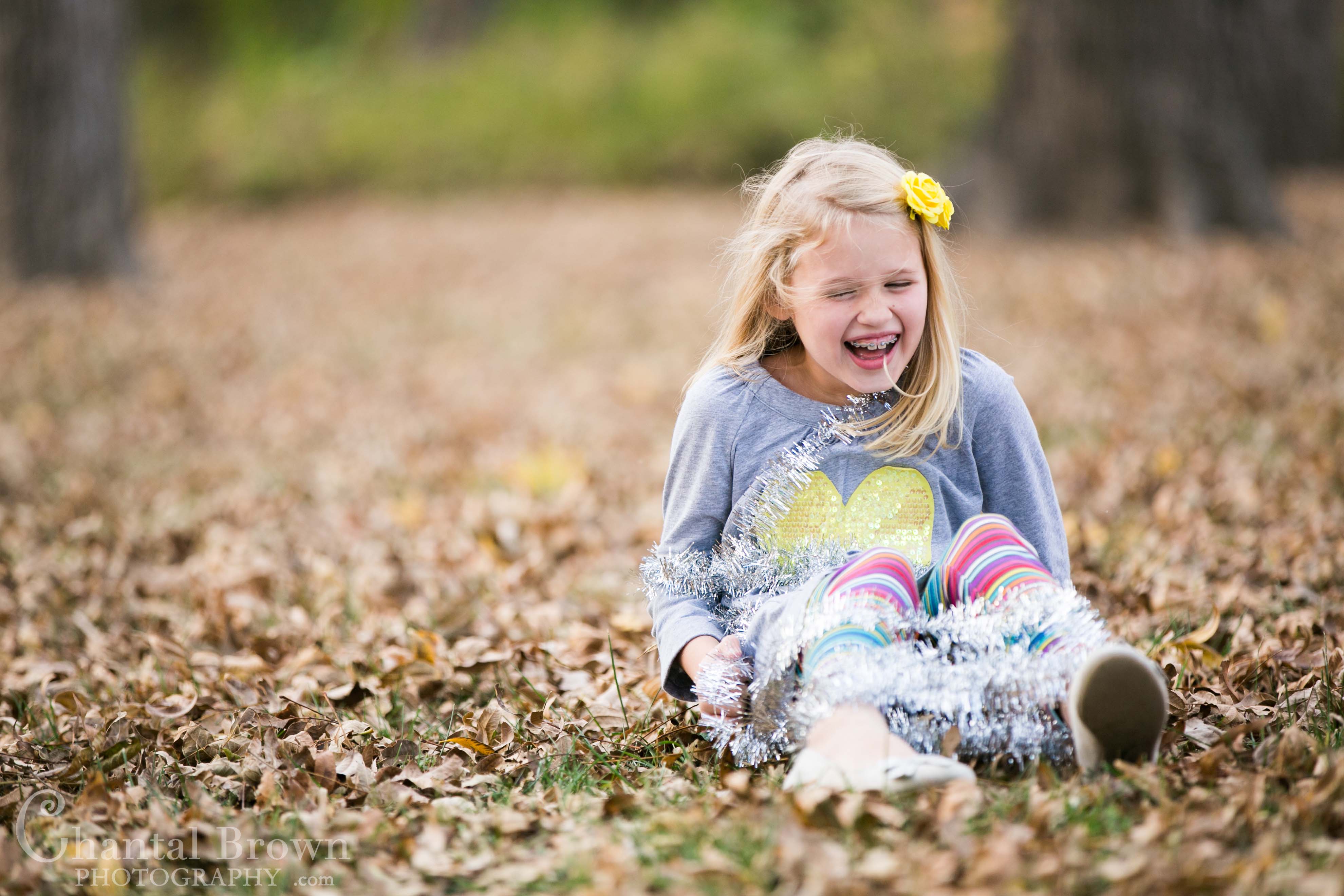 Richardson-Breckinridge-Park-15 Playing and having fun with Christmas decorations in pretty fall autumn color field covered with leaves Children Portrait at Breckinridge Park in Richardson Texas